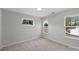 Neutral bedroom with three windows providing natural light and backyard views at 126 Meadow Glen Dr, Troutman, NC 28166