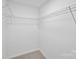 An organized walk-in closet with metal shelving and neutral carpeting at 126 Meadow Glen Dr, Troutman, NC 28166