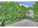 A charming deck overlooking lush trees and greenery, perfect for outdoor enjoyment and relaxation at 126 Meadow Glen Dr, Troutman, NC 28166