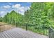 Wood deck with black metal railing offering views of a lush, green landscape at 126 Meadow Glen Dr, Troutman, NC 28166