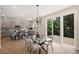 Elegant dining area with a modern chandelier, gray cabinets, and access to a deck at 126 Meadow Glen Dr, Troutman, NC 28166