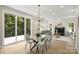 Inviting dining area with a glass table, modern chandelier, and sliding doors leading to an outdoor deck at 126 Meadow Glen Dr, Troutman, NC 28166