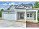 Lovely two-story home featuring a covered porch and attached two-car garage at 126 Meadow Glen Dr, Troutman, NC 28166
