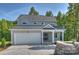 Charming two-story home with a gray exterior, two car garage, and a welcoming front porch at 126 Meadow Glen Dr, Troutman, NC 28166