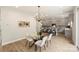 Open kitchen with gray cabinets, an island with bar seating, and modern lighting at 126 Meadow Glen Dr, Troutman, NC 28166