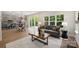 Open-concept living room with a dining area, a comfortable sofa, and large windows at 126 Meadow Glen Dr, Troutman, NC 28166