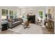 Inviting living room featuring a cozy fireplace, a comfortable sofa, and natural light at 126 Meadow Glen Dr, Troutman, NC 28166