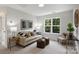 Comfortable living room with neutral-toned furniture, a large window, and stylish decor for relaxation at 126 Meadow Glen Dr, Troutman, NC 28166