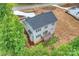 Aerial view of the rear of the home with deck, patio, and landscaping at 126 Meadow Glen Dr, Troutman, NC 28166