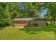 Aerial view of a house with a spacious backyard, wooden deck, and lush landscaping at 141 Dunlap Loop, Statesville, NC 28625
