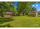 Spacious backyard with a brick house, deck, and shed, providing ample room for outdoor activities at 141 Dunlap Loop, Statesville, NC 28625