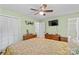Well-lit bedroom offering hardwood floors, ceiling fan, and seamless access to a private bathroom, perfect for relaxation at 141 Dunlap Loop, Statesville, NC 28625