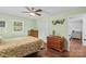 Spacious bedroom featuring hardwood floors, ceiling fan, and ample closet space for organization and storage at 141 Dunlap Loop, Statesville, NC 28625