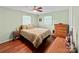 Comfortable bedroom with natural light, hardwood floors, and a ceiling fan, creating a relaxing and inviting atmosphere at 141 Dunlap Loop, Statesville, NC 28625