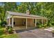 Exterior shot of a charming brick home with an attached carport and lush landscaping at 141 Dunlap Loop, Statesville, NC 28625