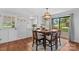 Inviting dining area with modern light fixture, table set for six, and sliding glass doors to the outdoor deck at 141 Dunlap Loop, Statesville, NC 28625
