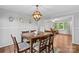 Charming dining room featuring a stylish light fixture, hardwood floors, and seamless flow into the adjacent living room at 141 Dunlap Loop, Statesville, NC 28625