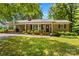 Charming brick ranch home featuring a lush green lawn and a welcoming covered entry at 141 Dunlap Loop, Statesville, NC 28625
