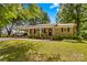 Charming brick home with a covered carport and meticulously maintained landscaping at 141 Dunlap Loop, Statesville, NC 28625