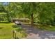 Charming single-story home with a long driveway, mature trees, and a well-manicured lawn at 141 Dunlap Loop, Statesville, NC 28625