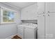Convenient laundry room with updated appliances, storage cabinets, and natural light at 141 Dunlap Loop, Statesville, NC 28625