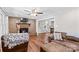 Open concept living room with a brick fireplace, seamlessly connecting to the dining area at 141 Dunlap Loop, Statesville, NC 28625