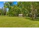 Lush backyard with storage shed surrounded by mature trees, enhancing privacy and natural beauty at 141 Dunlap Loop, Statesville, NC 28625