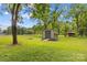 Backyard featuring a well-maintained shed with greenery, offering storage space and functionality at 141 Dunlap Loop, Statesville, NC 28625