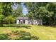 View of home's spacious backyard surrounded by mature trees, offering a private outdoor space at 142 Idlebrook Rd, Statesville, NC 28677