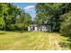 Expansive backyard with green lawn and surrounded by mature trees, ideal for outdoor living and recreation at 142 Idlebrook Rd, Statesville, NC 28677