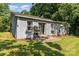 The backyard features a small patio, sliding glass doors, and an AC unit at 142 Idlebrook Rd, Statesville, NC 28677