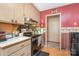 The kitchen features light brown cabinets, a black stove, and laminate countertops at 142 Idlebrook Rd, Statesville, NC 28677