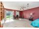 Spacious living room with a ceiling fan, red walls, and carpet flooring at 142 Idlebrook Rd, Statesville, NC 28677