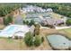 An aerial view of the community pool, clubhouse, tennis courts, and surrounding residences at 14611 Murfield Ct, Charlotte, NC 28278