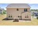 View of backyard with a built-in brick grill station and manicured lawn at 14611 Murfield Ct, Charlotte, NC 28278