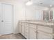 Bathroom featuring white cabinets, granite counters, double sinks and a large mirror at 14611 Murfield Ct, Charlotte, NC 28278