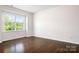 Bright bedroom with hardwood floors and a large window at 14611 Murfield Ct, Charlotte, NC 28278