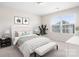 Bright bedroom featuring a tufted headboard, bedside tables, and a large window allowing natural light at 14611 Murfield Ct, Charlotte, NC 28278