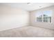 Bright bedroom featuring plush carpeting and natural light streaming through the large double-paned windows at 14611 Murfield Ct, Charlotte, NC 28278
