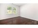 A large bedroom with hardwood floors and natural light streaming in from windows at 14611 Murfield Ct, Charlotte, NC 28278