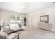 This bedroom features bright light from a window and a view to the en suite bathroom at 14611 Murfield Ct, Charlotte, NC 28278