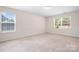 Bright bedroom featuring plush carpeting and natural light streaming through the large double-paned windows at 14611 Murfield Ct, Charlotte, NC 28278