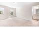 Bright bedroom with neutral walls, plush carpeting, and views into an en-suite bathroom at 14611 Murfield Ct, Charlotte, NC 28278