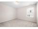 Bright bedroom featuring plush carpeting and natural light streaming through the double-paned window at 14611 Murfield Ct, Charlotte, NC 28278