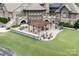 A patio area with seating and a fire pit outside of the community clubhouse at 14611 Murfield Ct, Charlotte, NC 28278