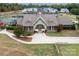 Community clubhouse with lush landscaping, decorative clock tower, and welcoming entrance at 14611 Murfield Ct, Charlotte, NC 28278