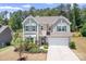 Charming two-story home featuring a two-car garage, landscaped yard, and inviting curb appeal at 14611 Murfield Ct, Charlotte, NC 28278