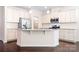 Bright kitchen boasts white cabinets, stainless steel appliances, and a granite island at 14611 Murfield Ct, Charlotte, NC 28278