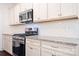 The kitchen has stainless appliances, subway tile backsplash and granite counters at 14611 Murfield Ct, Charlotte, NC 28278