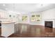 Bright living room featuring dark hardwood floors, fireplace and large windows overlooking the property at 14611 Murfield Ct, Charlotte, NC 28278